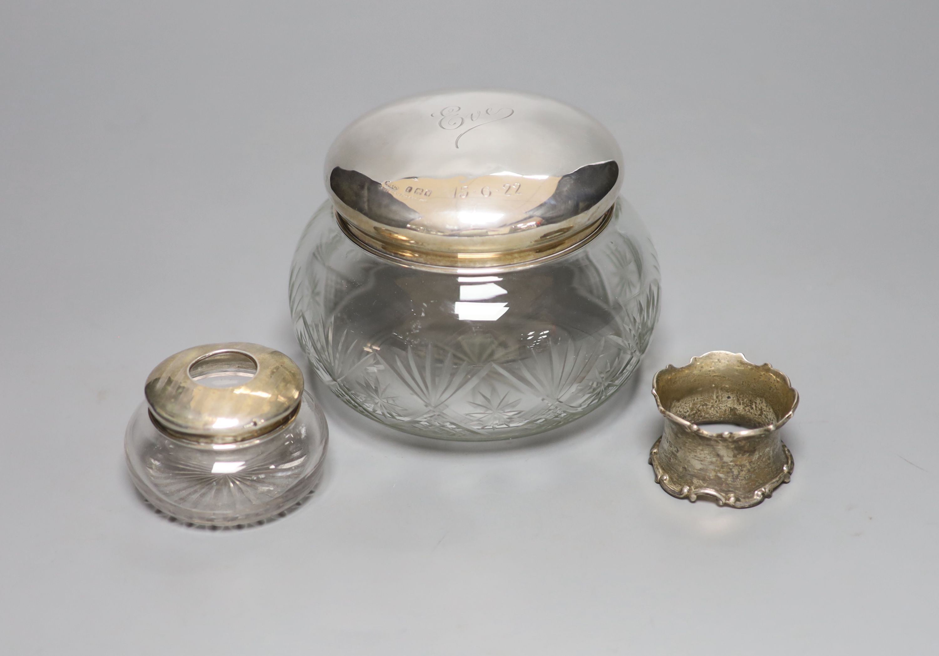 A 1920's silver mounted cut glass powder bowl, a similar small hair tidy and a silver napkin ring.